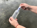 A person with a message in a crystal bottle Royalty Free Stock Photo