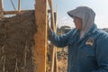 hands a man building a wall with reed and mud Royalty Free Stock Photo