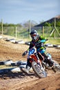 Person, motorcycle and dirt race track competition as .professional in action, danger or fearless risk. Bike rider, off