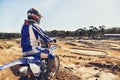 Person, motorcyclist or expert on dirt track for extreme sports, outdoor competition or race. Rear view of professional Royalty Free Stock Photo