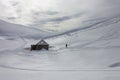 Person near an abandoned house on snowy mountains