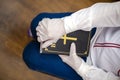 Person, nurse or doctor with gloves stand in prayer with Bible in hand Royalty Free Stock Photo