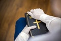 Person, nurse or doctor with mask and gloves stand in prayer with Bible in hand