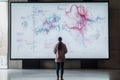 Person observing a large data visualization display in a modern exhibition area Royalty Free Stock Photo