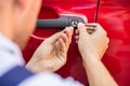 Person Opening Car Door With Lockpicker Royalty Free Stock Photo