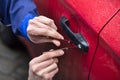 Person Opening Car Door With Lockpicker Royalty Free Stock Photo