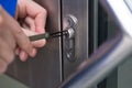 Person Opening Door With Lockpicker Royalty Free Stock Photo