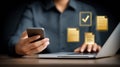 Person managing digital documents using phone and laptop Royalty Free Stock Photo