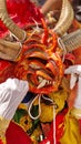 Person in an orange devil mask at the Diablada