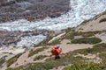 Man walks on footpath in Himalayas with mountain river in the background