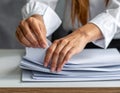 Person Organizing Documents with Hand Sorting Papers Royalty Free Stock Photo