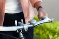 Person, outdoor and hands on bicycle handle, frame and exercise on bike in summer, park or neighborhood. Cycle, ride and Royalty Free Stock Photo