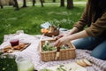 person, packing eco-friendly picnic basket for day in the park