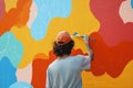 A person painting a feature wall in a creative pattern