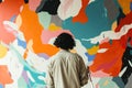 A person painting a feature wall in a creative pattern