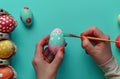 Person paints vibrant easter eggs in a joyful celebration, easter crafts picture Royalty Free Stock Photo