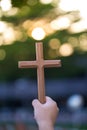 Person palm hands to hold holy cross, crucifix to worship. christian in catholic Eucharist bless god ceremony. People and religion Royalty Free Stock Photo