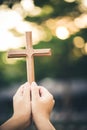 Person palm hands to hold holy cross, crucifix to worship. Royalty Free Stock Photo