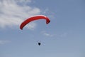 Person paragliding above a beautiful mountainous landscape