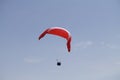 Person paragliding above a beautiful mountainous landscape