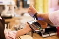 Person paying at cafe with smart watch wirelessly on POS terminal Royalty Free Stock Photo