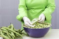 Person peeling broad beans