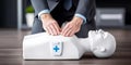 Person performing cardiopulmonary resuscitation on training dummy, learning emergency life saving first aid techniques Royalty Free Stock Photo