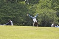 Person performing a cartwheel on the grass in a Tokyo garden