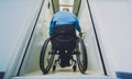 Person with a physical disability in a wheelchair using lift in building