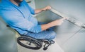 Person with a physical disability in a wheelchair using lift in building