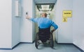 Person with a physical disability in a wheelchair using lift in building