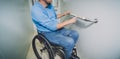 Person with a physical disability in a wheelchair using lift in building