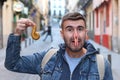 Person picking up stinky dog poop on the street Royalty Free Stock Photo