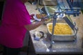 Person in pink teeshirt filling plate at breakfast buffet with scrambled eggs and waffle