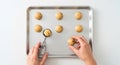 Hands preparing cookie dough on baking tray Royalty Free Stock Photo
