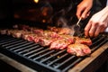 person placing raw ribeye steak on hot grill