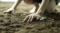 A person is planting seeds in the dirt