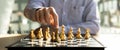 Person playing chess board game, business man concept image holding chess pieces like business competition and risk management, Royalty Free Stock Photo