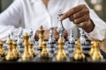 Person playing chess board game, business woman concept image holding chess pieces like business competition and risk management, Royalty Free Stock Photo