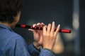 Person playing chinese flute with both hands showing and bokeh background Royalty Free Stock Photo