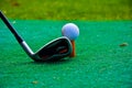 Person playing golf and putting a ball close up elevated view