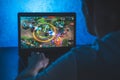 Person playing league of legends video game on computer