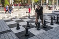 Person playing on one of the four giant chess sets on Sainte-Catherine Street in Montreal