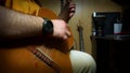 A person plays an acoustic guitar. Guitarist with guitar close-up