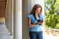 Person plays photos in camera at Ancient Greek columns, Athens, Greece Royalty Free Stock Photo