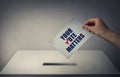 Person at the polling station holding a ballot paper in his hand with the message your vote matters. People legal and democratic