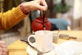 Person pouring herbal tea Royalty Free Stock Photo