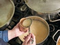 Person pouring home made soup on a takeaway container, no faces shown Royalty Free Stock Photo