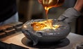 A Person Pouring Liquid into a Bowl on a Table