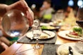 Person pouring vodka from decanter Royalty Free Stock Photo